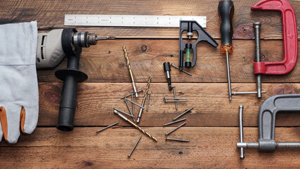 Collection of woodworking tools on a wooden background.