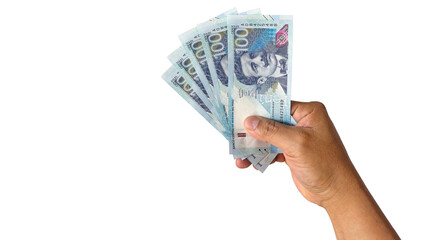 male hand holding new bills in peruvian sol on a white background new bills