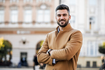 Attractive business man standing outdoors
