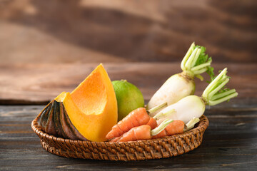 Fresh organic vegetable from local farmer market in basket on wooden background, Still Life