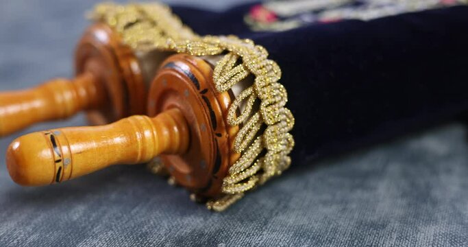 Jewish holidays in a synagogue prayer items with prayer torah scroll on soft focus