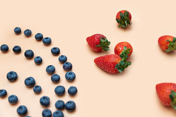 heaps of blueberries and strawberries are laid out with a close-up pattern on a beige background