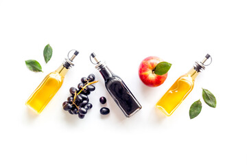 Red wine and apple cider vinegar with grapes and red apples