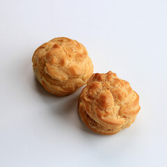 Two Choux Cream on White Background. Profiterole, Eclair, Cream puff. Isolated