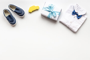 Baby boy blue shoes with bodysuit. Newborn set background
