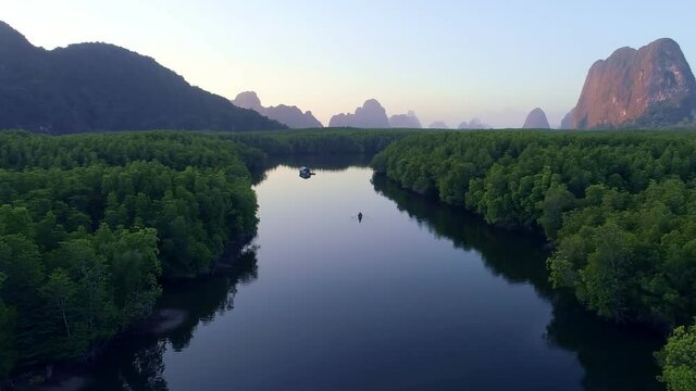 Aerial view drone shot of beautiful sunrise sky in the morning sunrise Drone is flying over sea and mangrove forest Landscape High angle view Dynamic aerial shot Amazing nature view