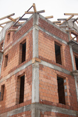 brick house under construction in Bistrita, concrete belts for brick construction  Romania, 2022, January 