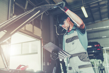 Caucasian Car Mechanic Electronic Elements Technician Checking on an Issue