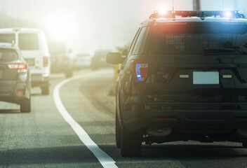 Highway Police Patrol Cruiser on Side of a Road - obrazy, fototapety, plakaty