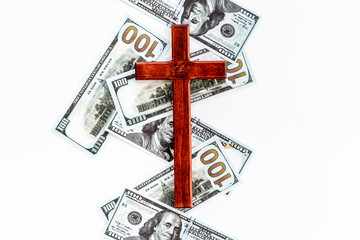 Money and religion. Wooden cross on dollars