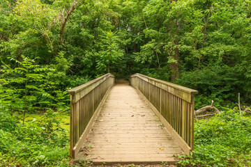 A wooden footbridge crossing the C & O Canal, at Chesapeake & Ohio Canal National Historical Park,...