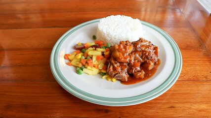 stewed pork ,pork with rice and sauce or rice topped with stew pork.