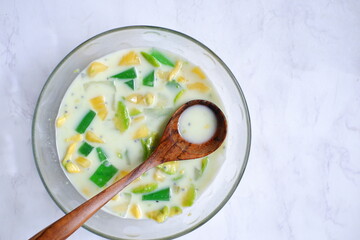 a bowl of  iced mix fruit and milk against white background 