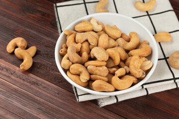 Cashew nuts in white bowl on the table, Healthy snack, Vegetarian food.