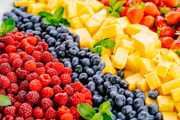 fruit assorted. raspberries, blueberries, pineapple and strawberries