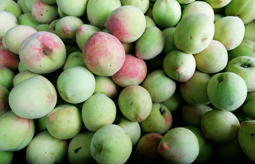 Fresh peaches on the shelf of a fruit shack on the side of the street in Sapa, Vietnam