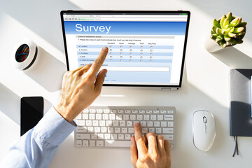 Obraz na płótnie Canvas Businessperson Filling Online Survey Form