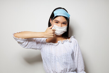 Charming young Asian woman two medical masks on the head protection Lifestyle unaltered