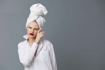 glamorous woman with a towel on his head in a white shirt studio model unaltered