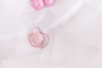 Silicone baby soother , pacifier,  on a white airy background with copy space. New born concept