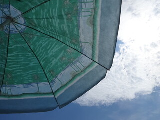 Green Beach Sunshade on Sky Background