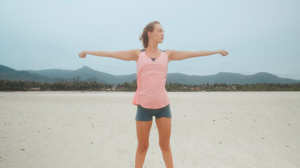 Fitness woman stretching joints warm up on tropical beach