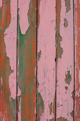Old wooden background with multicolor paint.