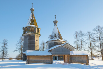 Ancient wooden temple complex of the Epiphany on a February sunny day. Pogost (Oshevenskoe). Arkhangelsk region, Russia