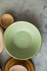 Ceramic plates and cup on wooden surface. Overview empty food table with tableware. 