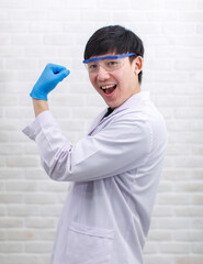Portrait studio shot Asian professional male scientist in white lab coat rubber gloves standing...