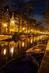 Alley in Amsterdam, The Netherlands, with boats at night