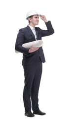 Front view of young architect man in hardhat holding blueprints walking away