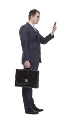 full length picture of a young business man walking forward with a briefcase in one of his hands