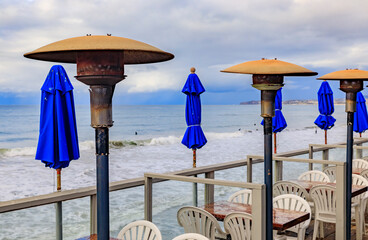 Blue umbrellas at a cafe on the beach in San Clemente California, USA - obrazy, fototapety, plakaty