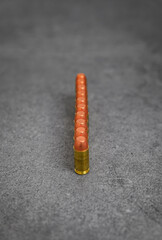 45 ACP caliber full metal jacket bullets unfired rounds lined up on a stone surface
