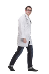 Male doctor walking isolated over a white background -side view