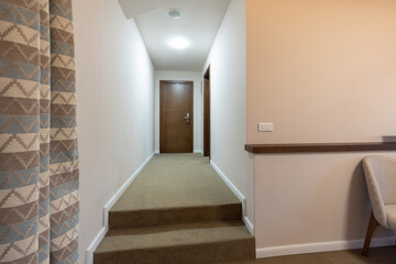 Interior of a carpeted hotel corridor doorway