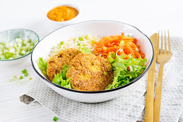 Orzo pasta, carrots and chicken burgers in white bowl. Risoni pasta. Lunch.