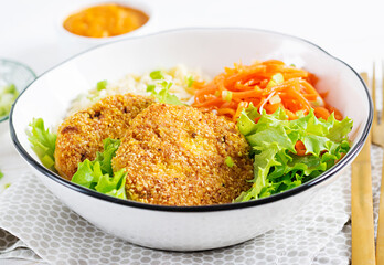 Orzo pasta, carrots and chicken burgers in white bowl. Risoni pasta. Lunch.