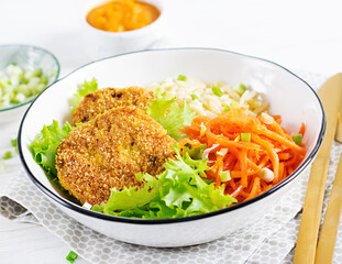Orzo pasta, carrots and chicken burgers in white bowl. Risoni pasta. Lunch.
