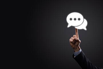 Businessman holding a message icon, bubble talk notification sign in his hands. Chat icon, sms icon, comments icon, speech bubbles