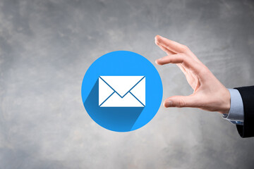 Businessman hand holding letter icon,email icons.Contact us by newsletter email and protect your...