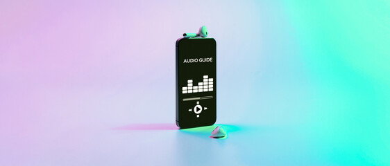Audio guide online app on digital mobile smartphone screen with music headphones on neon background. Devices for listening audioguide to excursions.