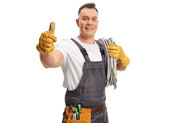 Electrician carrying cables on his shoulder and gesturing thumbs up