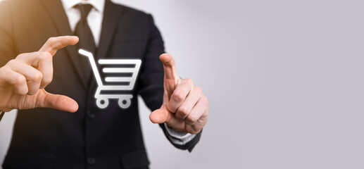 Business man hold in hand shopping cart icon.Shopping online concept.basket hologram. Online shopping, online store application in a smartphone. Digital Marketing Online