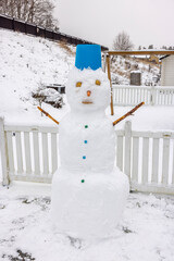 Close up of a funny snowman in winter garden. Sweden.