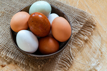 Assortment of free range eggs on wooden table