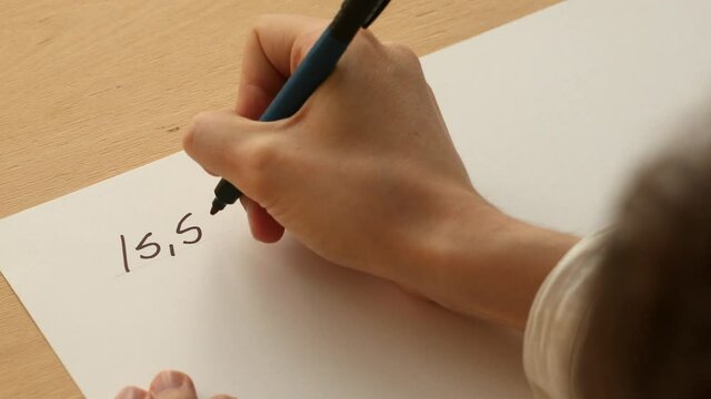 Young mathematician writes the formula for the circle length on the paper. Date of shooting day 23 December 2021 year, MSK time. This video was filmed in Russia.