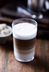 Coffee with milk on wooden background. Soft focus. Close up.