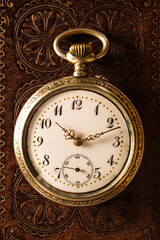 106= Old classic antique pocket watch on leather bible background